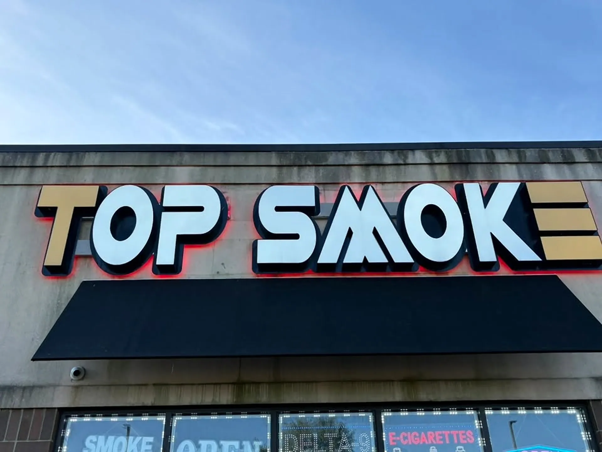 Backlit storefront sign face cleaned of road film