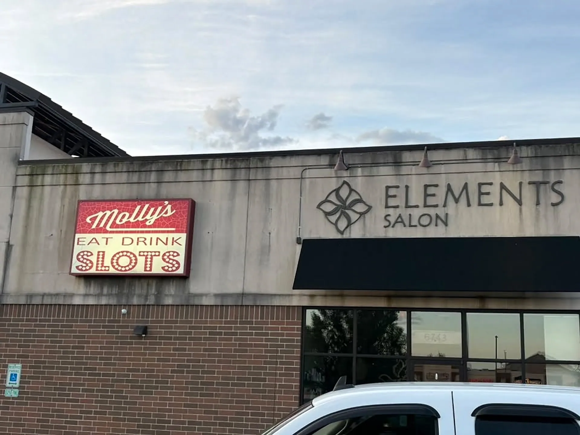 Strip-mall frontage with cleaned awnings and brick columns
