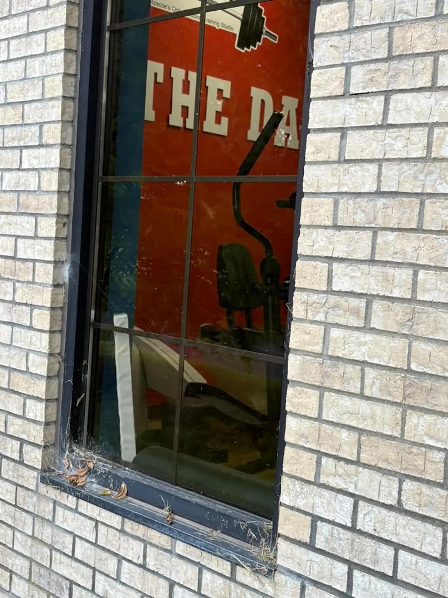 Window and painted brick cleaned around a shop entrance