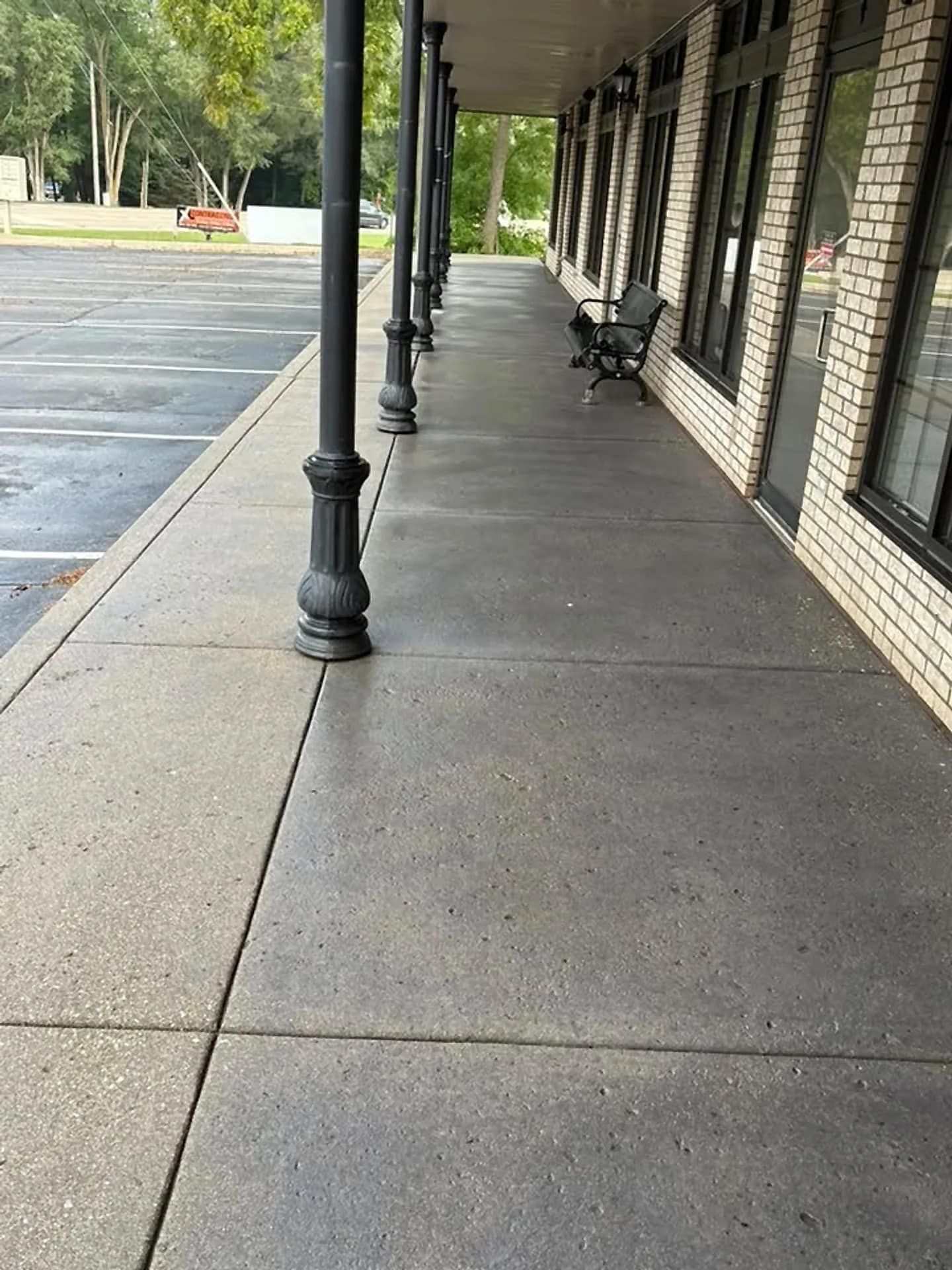 Covered strip-mall walkway with concrete washed end to end