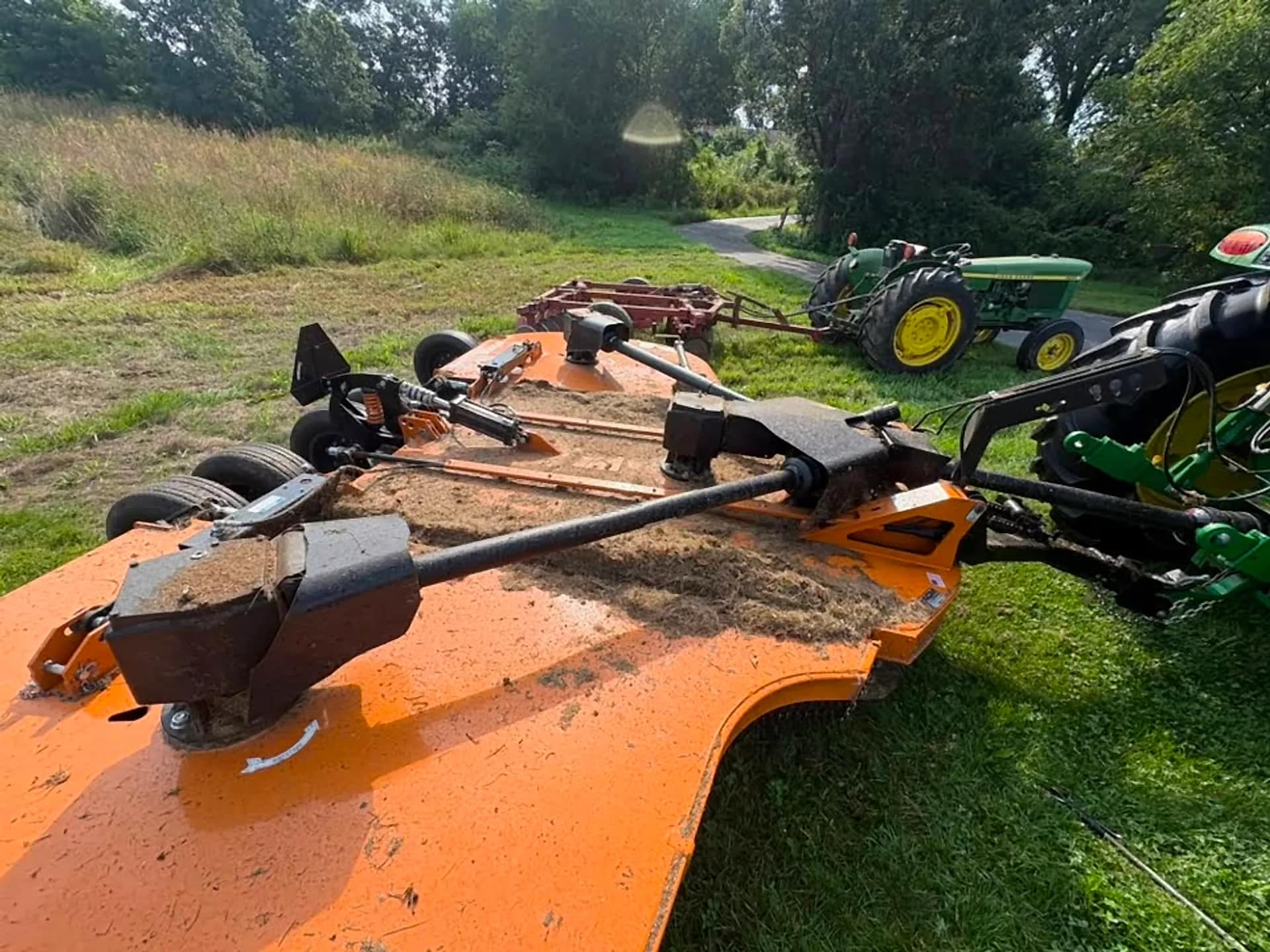 Rotary cutter implement washed clean of field debris
